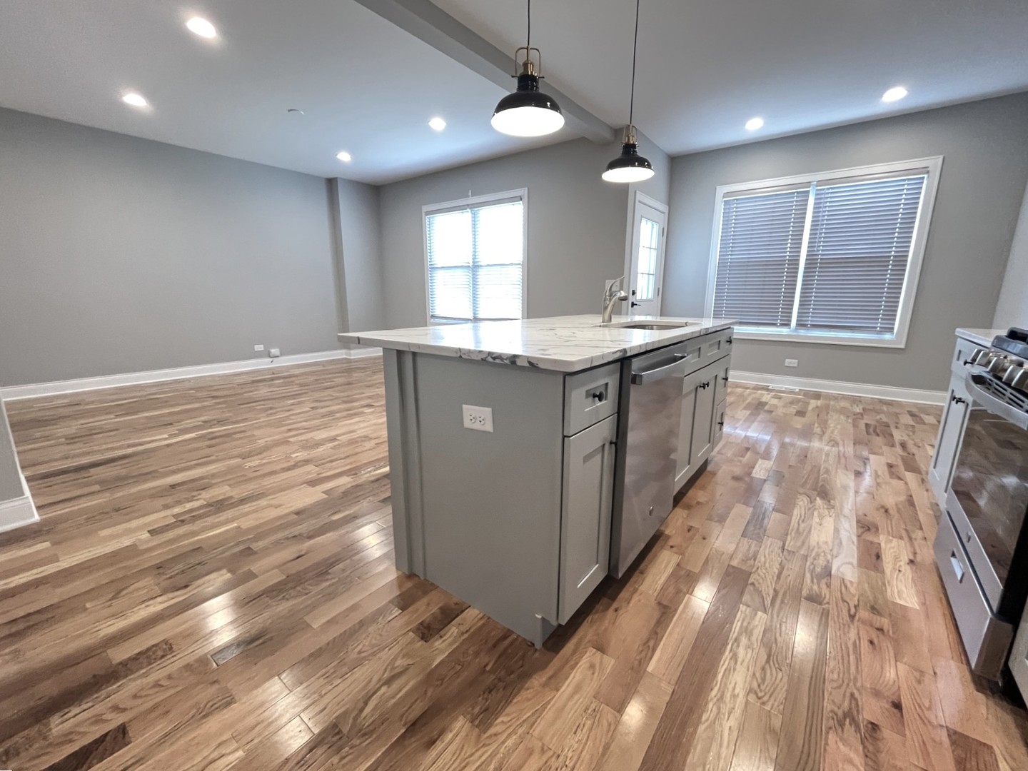 994 Center Drive Marengo, IL 60152 - Photo 7 of 23 a large kitchen with kitchen island wooden floors granite counter tops and a window