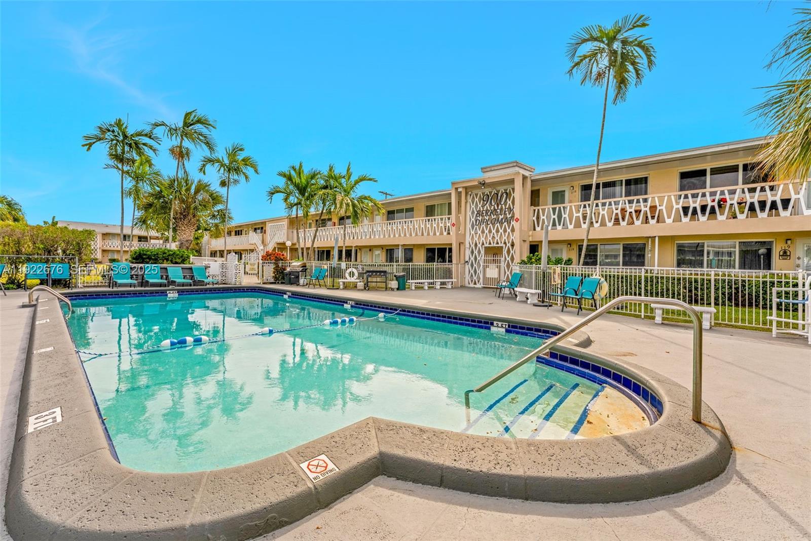 900 Atlantic Shores Boulevard, Unit 105 Hallandale Beach, FL 33009 - Photo 16 of 22 a view of a swimming pool with a lounge chairs