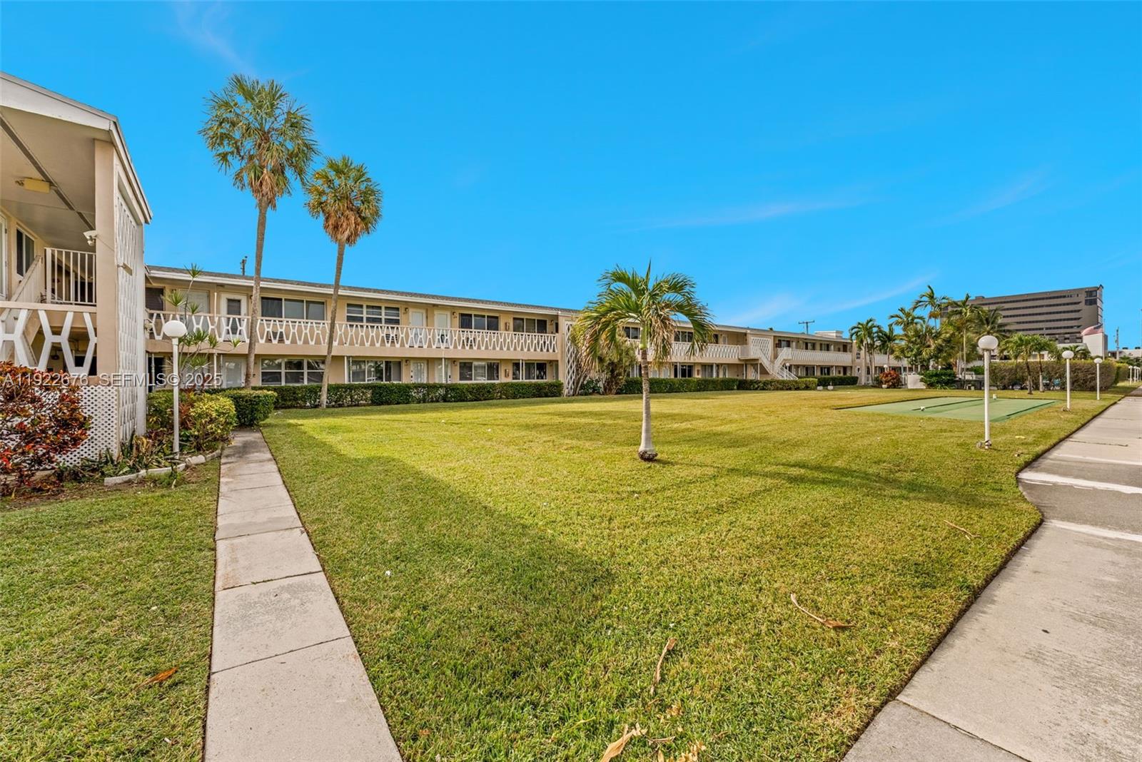 900 Atlantic Shores Boulevard, Unit 105 Hallandale Beach, FL 33009 - Photo 3 of 22 a view of a swimming pool with a yard