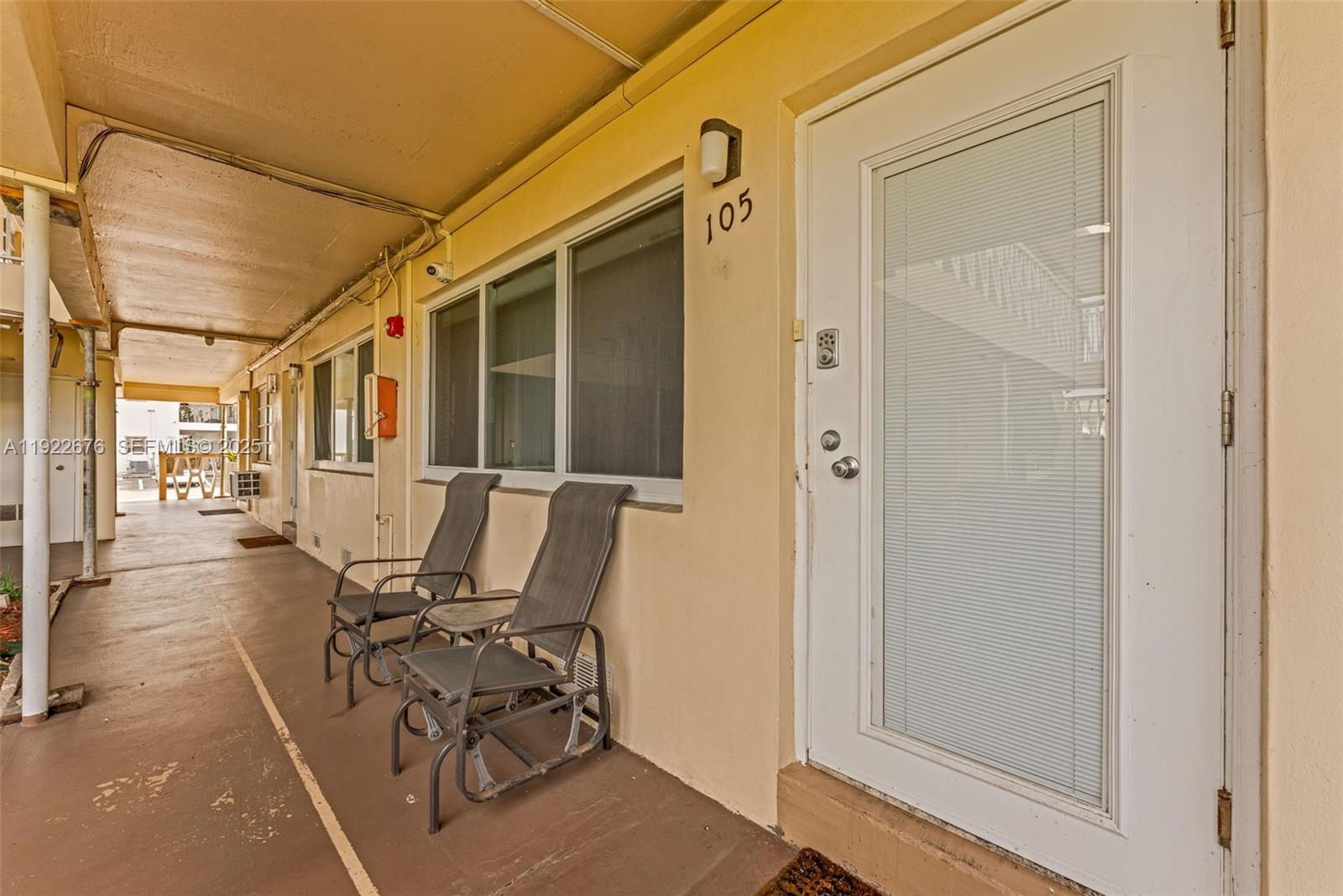 900 Atlantic Shores Boulevard, Unit 105 Hallandale Beach, FL 33009 - Photo 5 of 22 a view of a patio with table and chairs and wooden floor