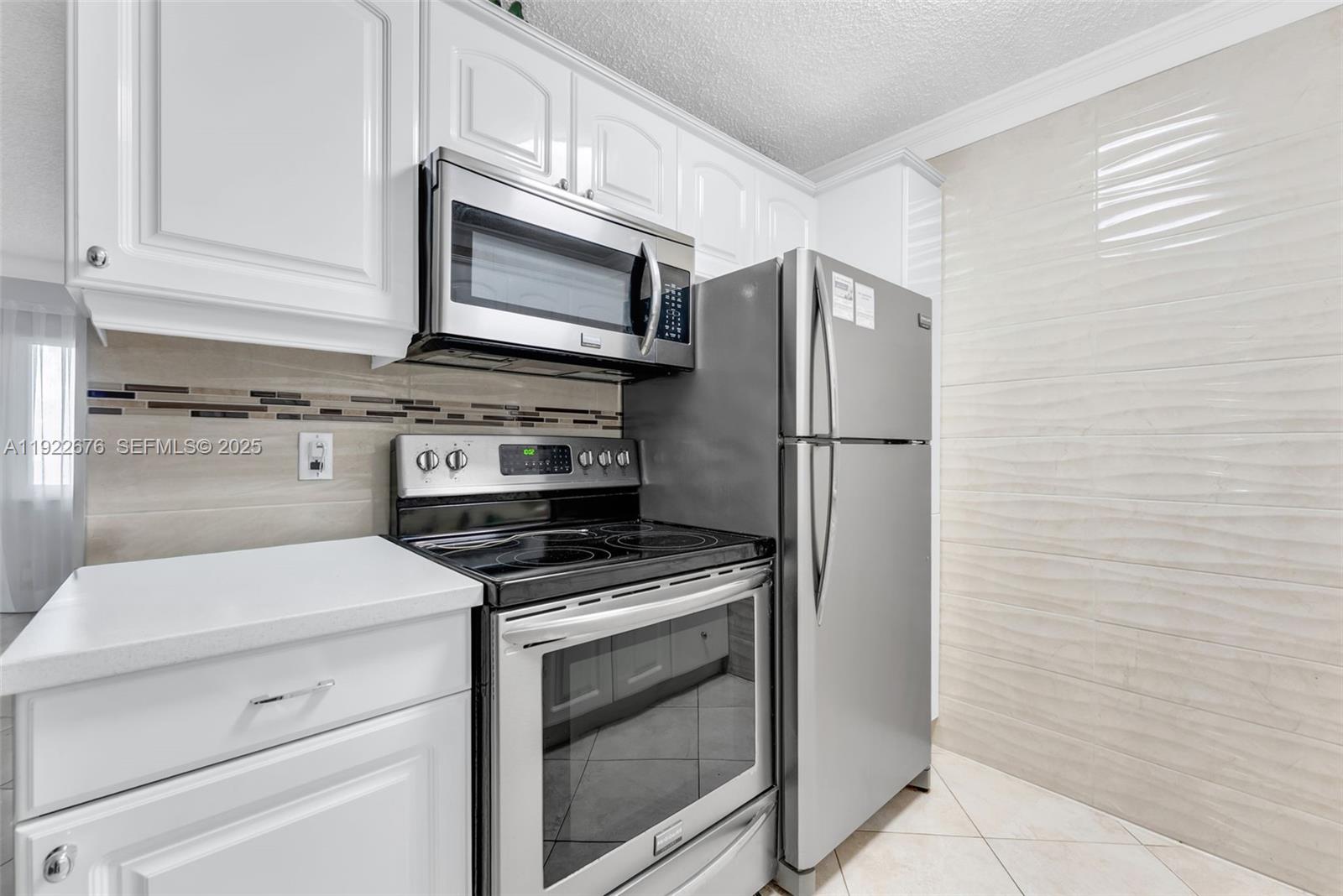 900 Atlantic Shores Boulevard, Unit 105 Hallandale Beach, FL 33009 - Photo 9 of 22 a kitchen with a stove microwave and refrigerator