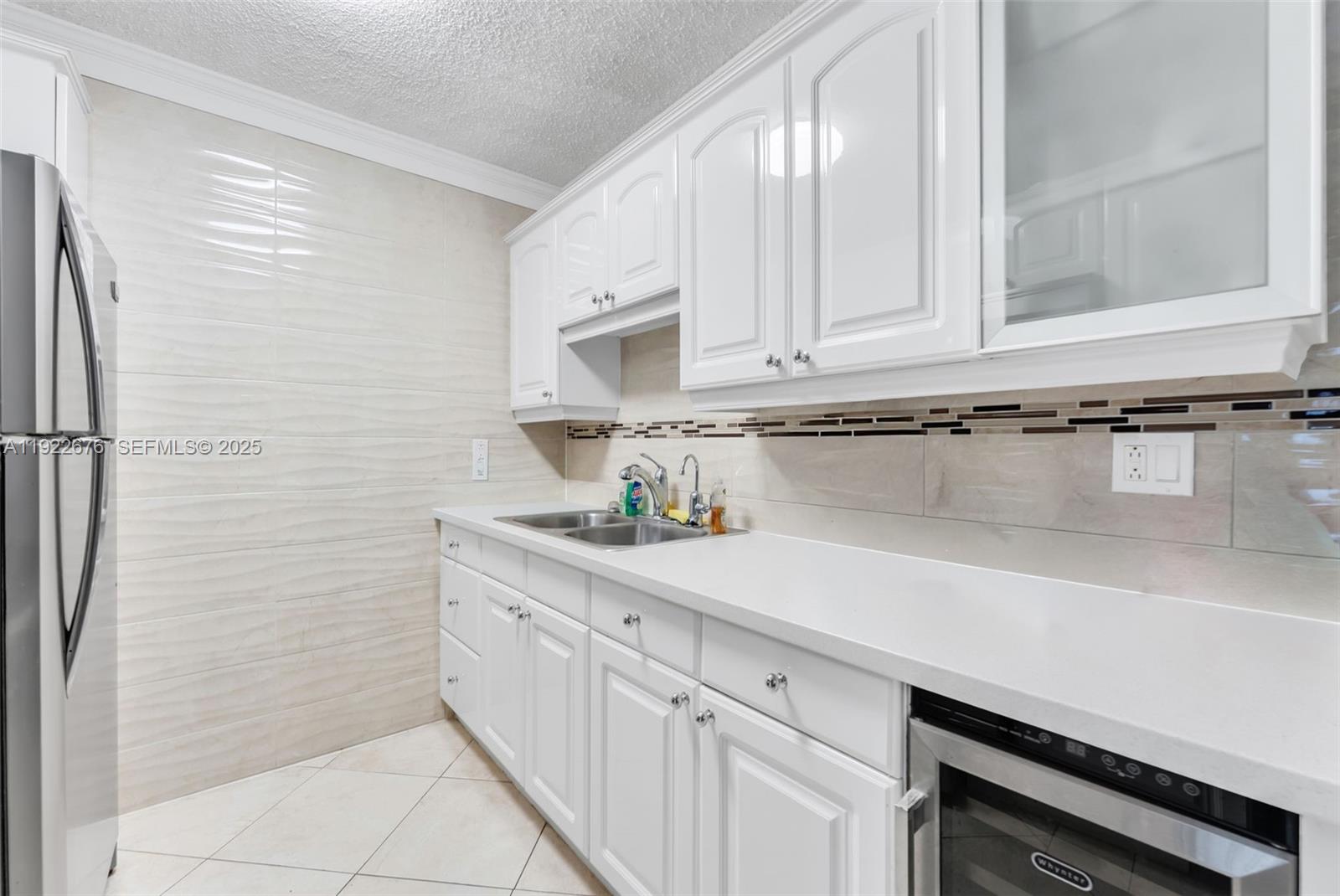 900 Atlantic Shores Boulevard, Unit 105 Hallandale Beach, FL 33009 - Photo 10 of 22 a kitchen with a sink and cabinets