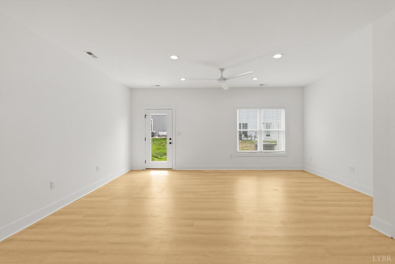 556 Leesville Road, Unit 406 Lynchburg, VA 24502 - Photo 15 of 39 a view of an empty room with wooden floor and a window