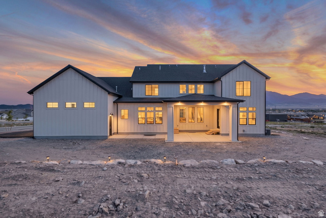 2828 Jojo Road Eagle Mountain, UT 84005 - Photo 53 of 63 Modern farmhouse exterior featuring white vertical siding and dark-trimmed windows