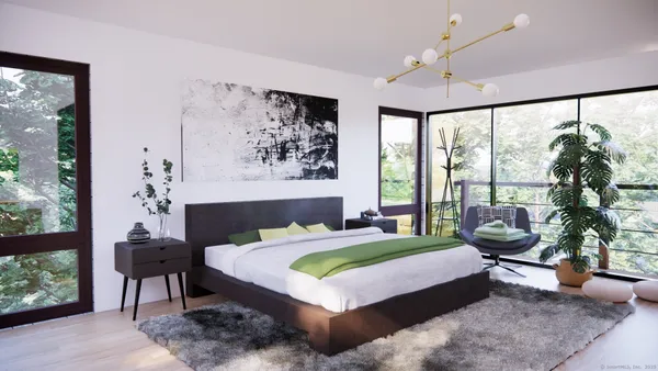 a bedroom with a large bed and a large window