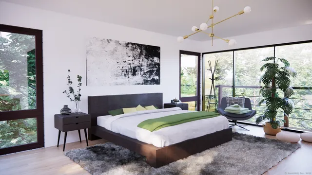 a bedroom with a large bed and a large window