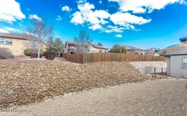 a view of a yard with a large tree