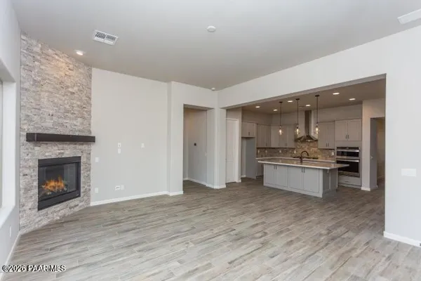 a large kitchen with kitchen island a sink stainless steel appliances and cabinets