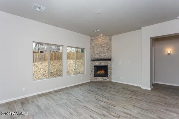 wooden floor in an empty room with a fireplace