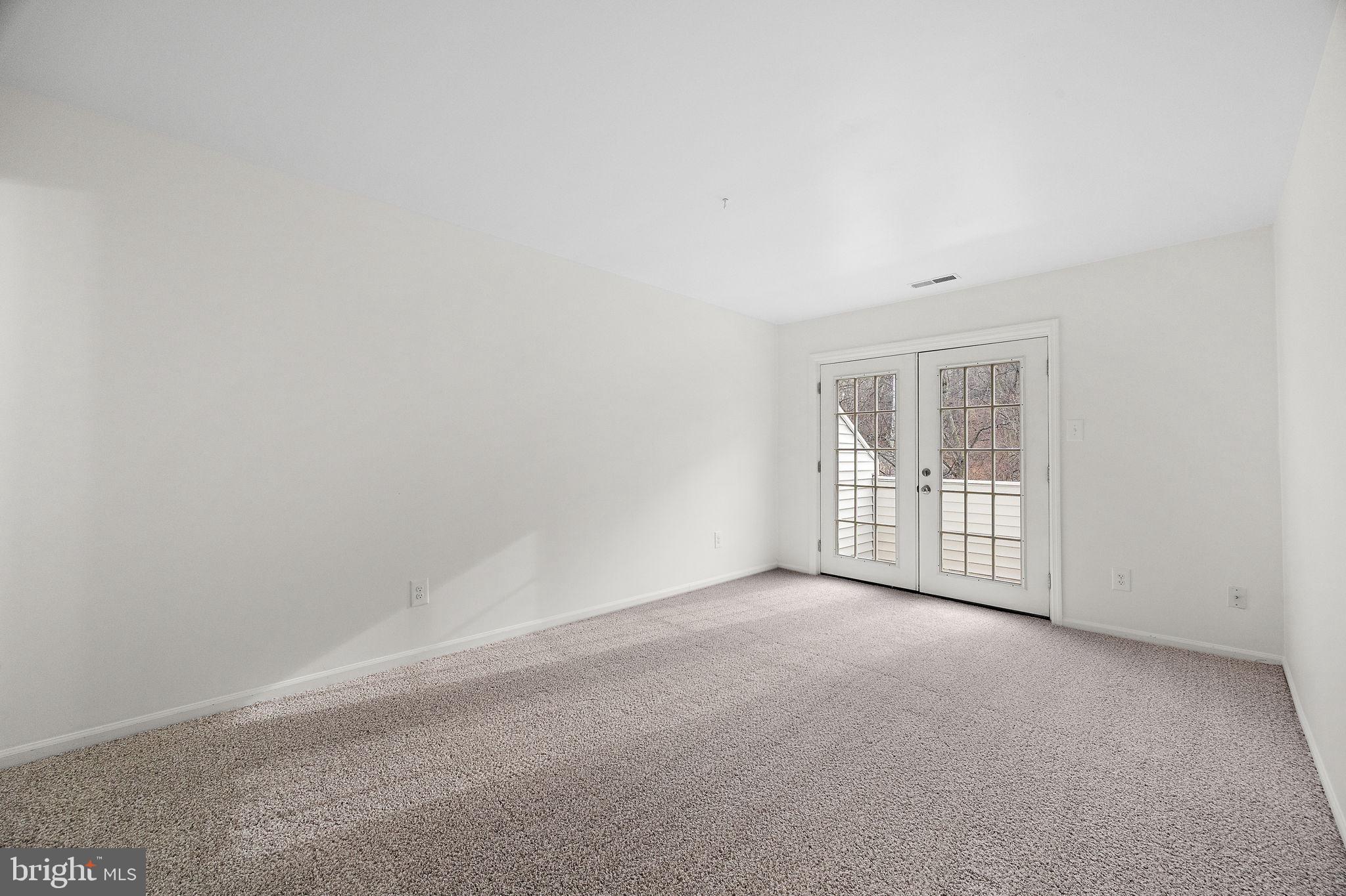 129 Emery Court, Unit A Newark, DE 19711 - Photo 11 of 15 an empty room with windows