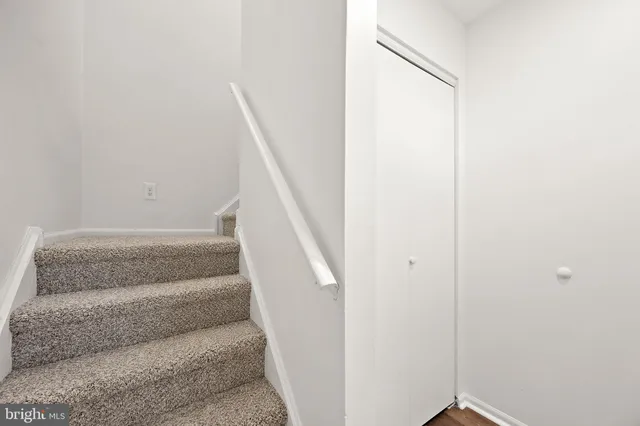 a view of staircase with white walls