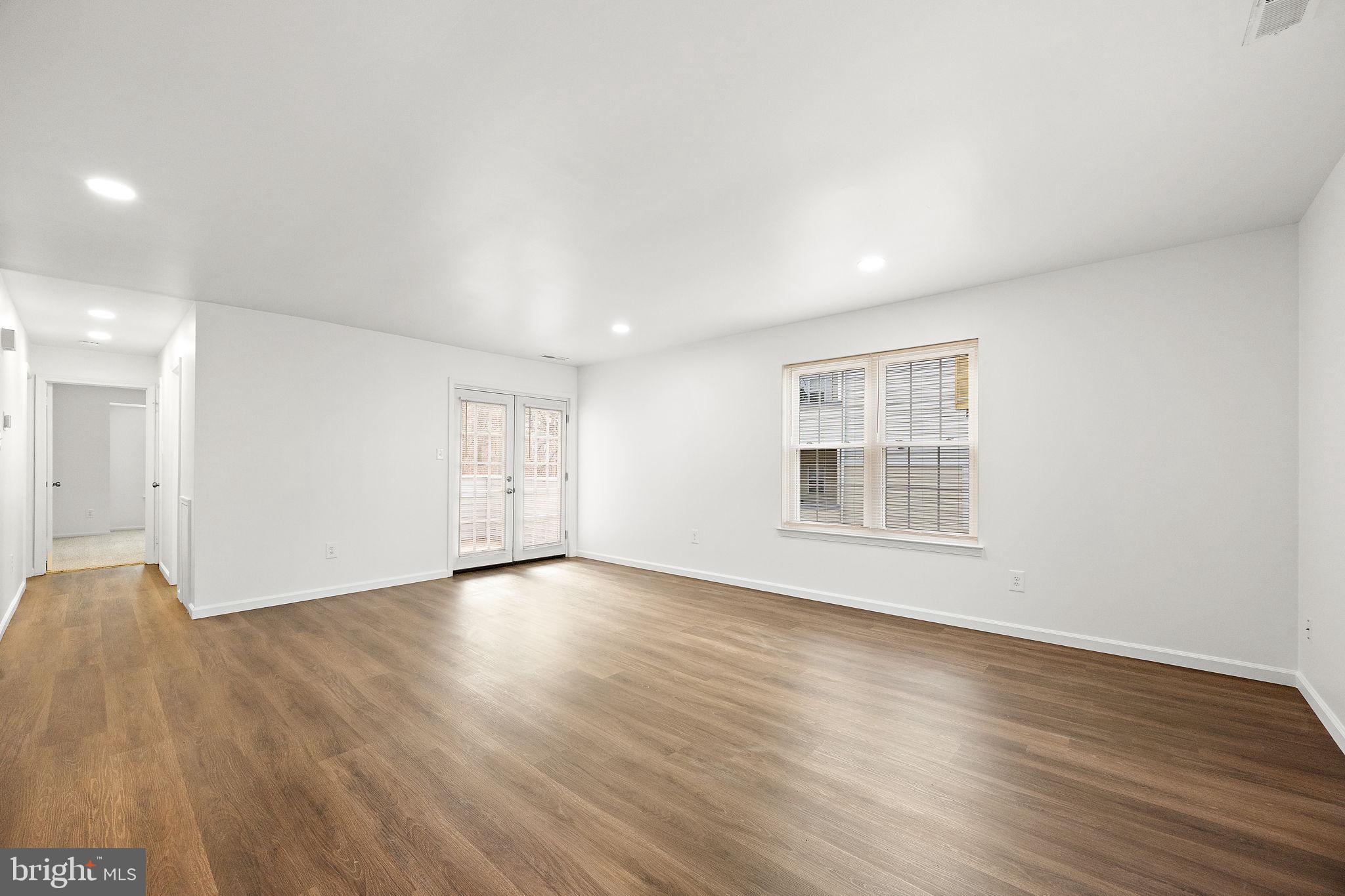 129 Emery Court, Unit A Newark, DE 19711 - Photo 3 of 15 a view of an empty room with wooden floor and a window