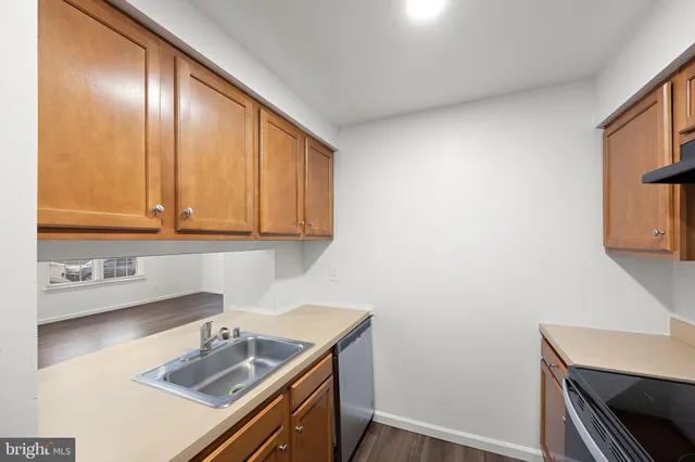 a kitchen with a sink cabinets and window