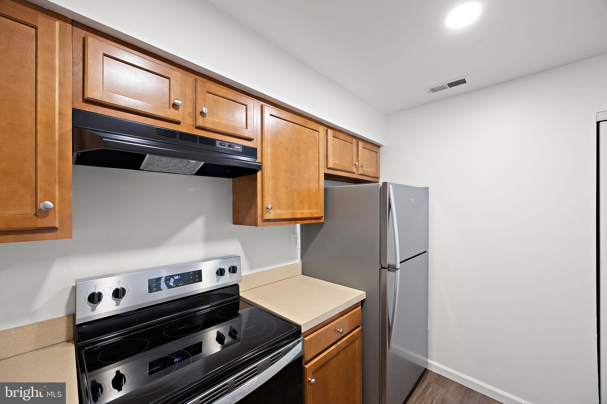 129 Emery Court, Unit A Newark, DE 19711 - Photo 6 of 15 a kitchen with stainless steel appliances granite countertop a stove and a refrigerator