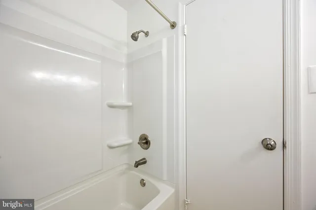 a bathroom with a tub and shower