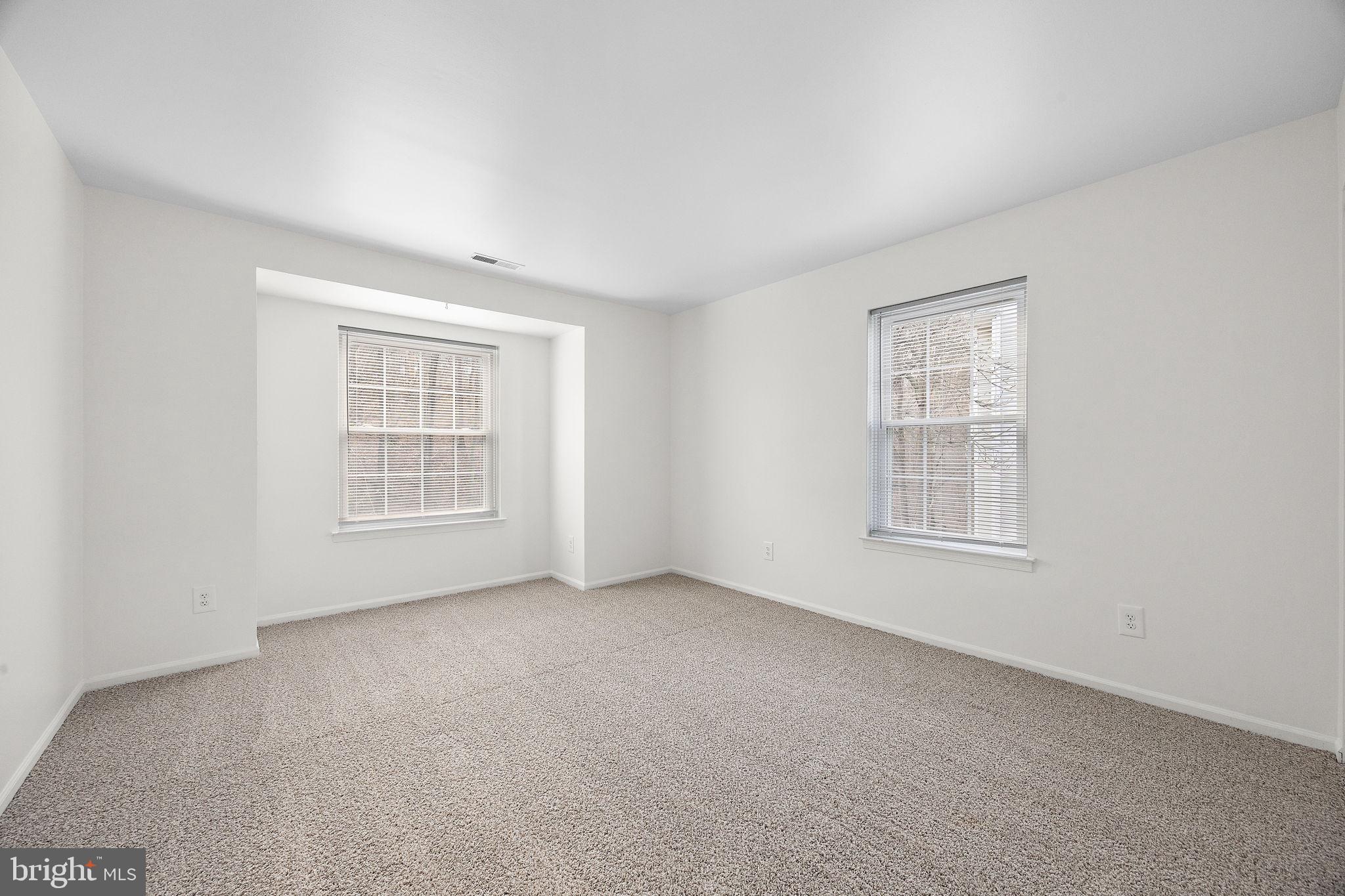 129 Emery Court, Unit A Newark, DE 19711 - Photo 9 of 15 an empty room with windows