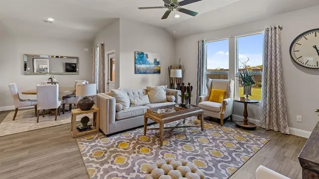 a dining room with furniture and kitchen view