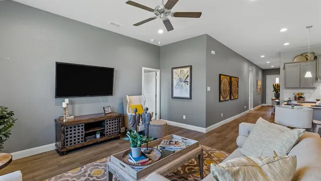 a living room with furniture a fireplace and a flat screen tv