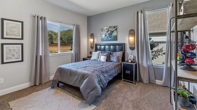 a bedroom with a bed and a mirror on dresser