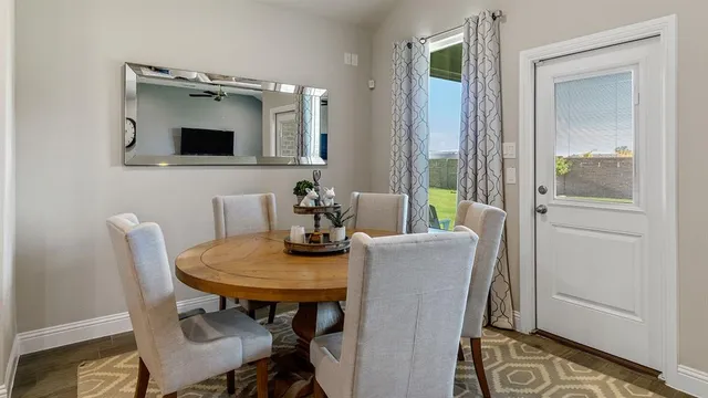 a kitchen with a sink a stove and chairs