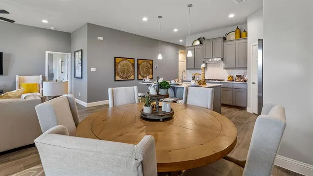 a kitchen with a sink cabinets and wooden floor