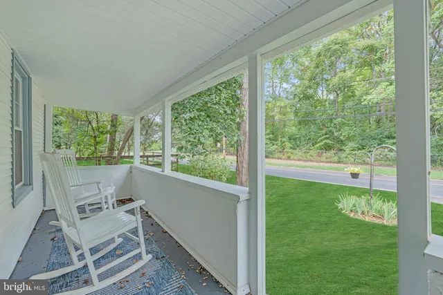 a view of an entryway with wooden floor and door