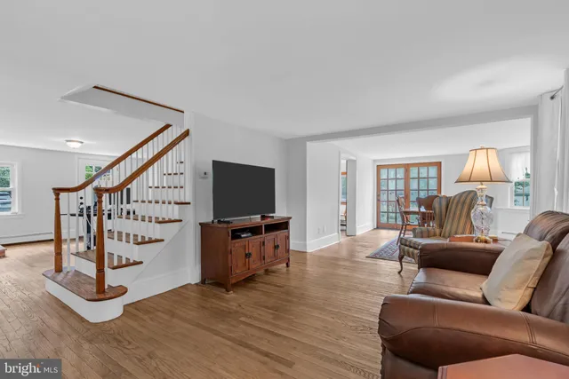 a dining room with furniture and wooden floor