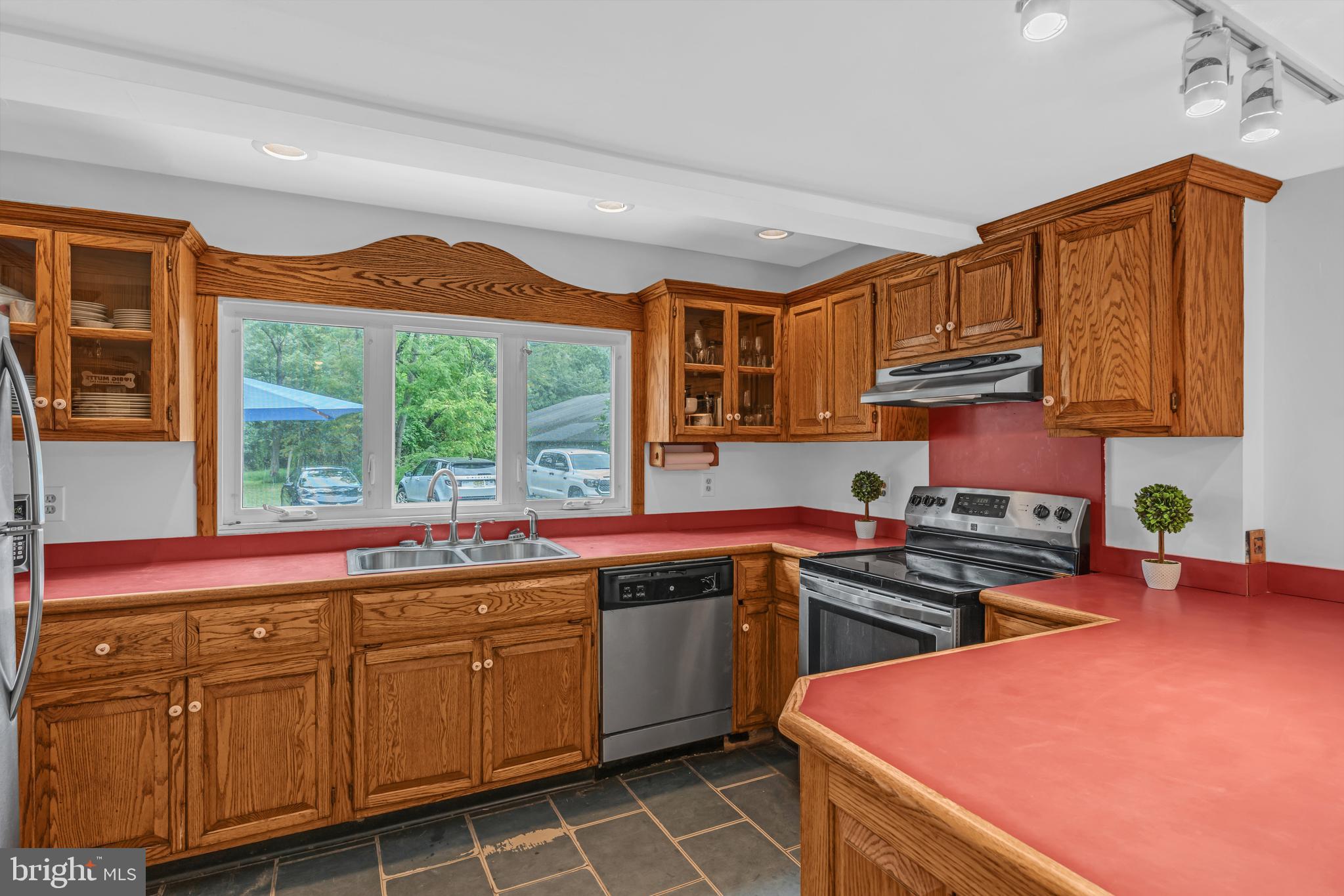 14 Maxim Road Howell, NJ 07731 - Photo 30 of 55 a kitchen with stainless steel appliances a stove a sink and a microwave