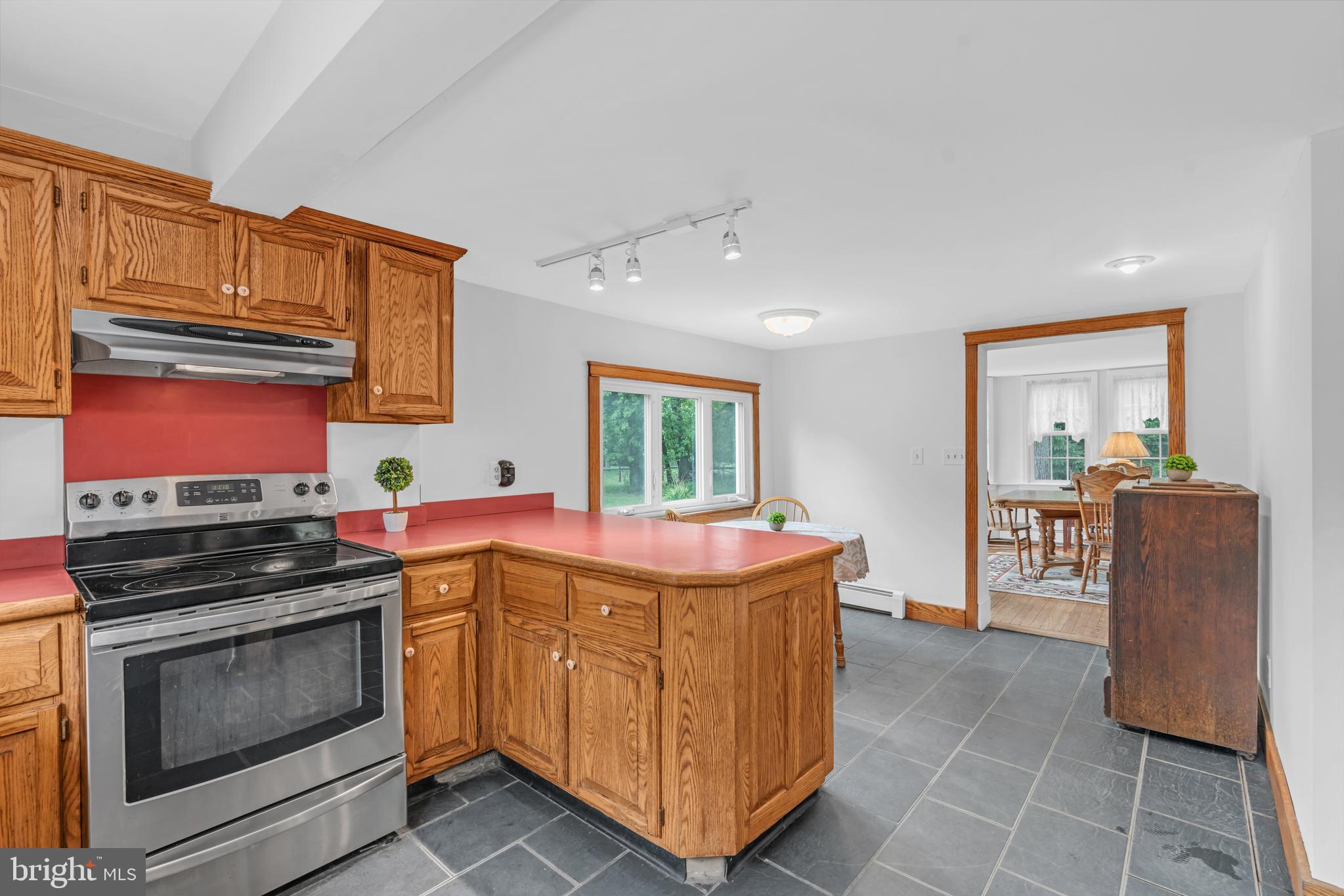 14 Maxim Road Howell, NJ 07731 - Photo 33 of 55 a kitchen with kitchen island granite countertop a stove and a refrigerator