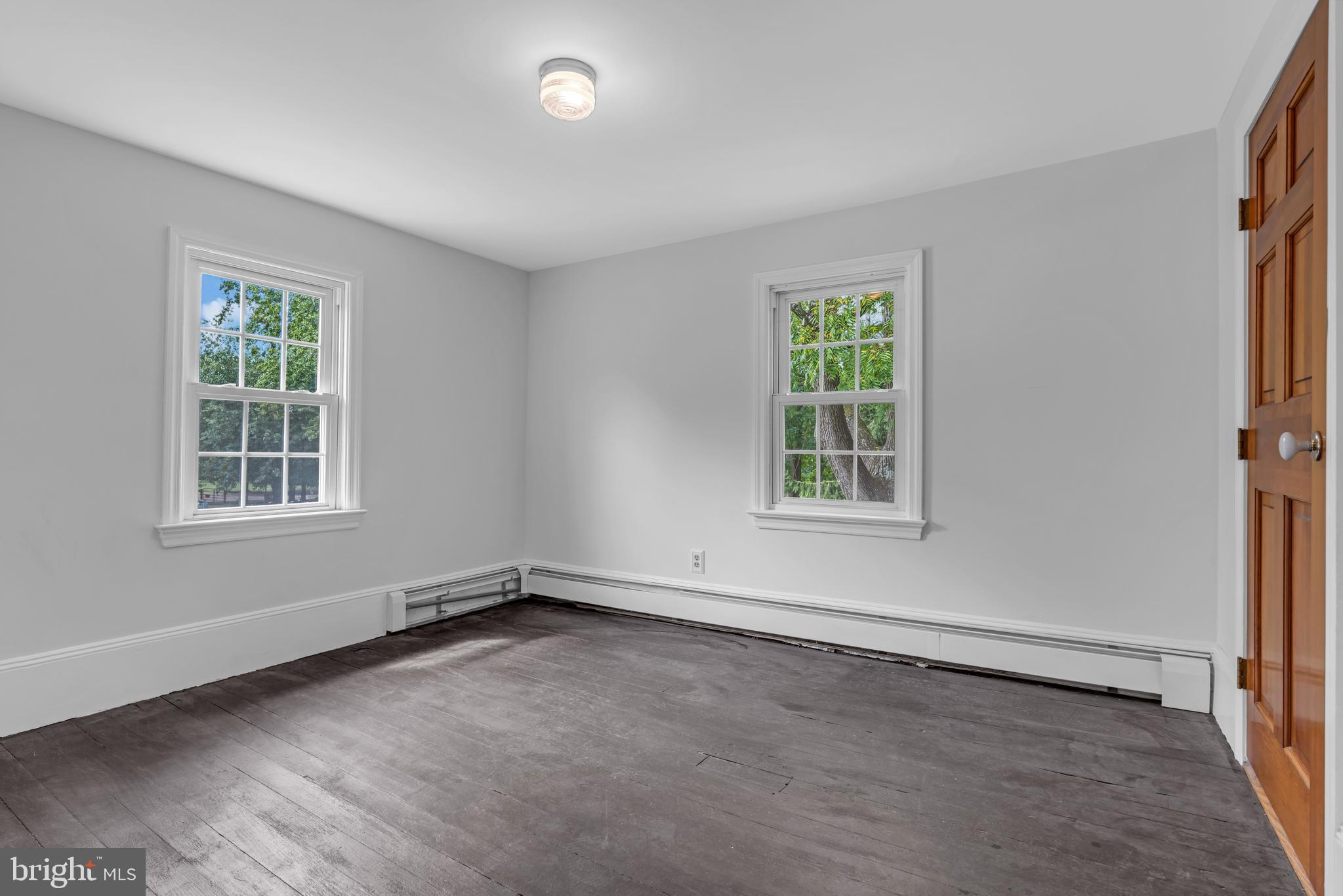 14 Maxim Road Howell, NJ 07731 - Photo 43 of 55 an empty room with wooden floor and windows