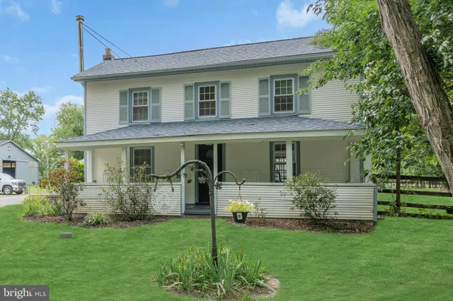 a house with green field in front of it