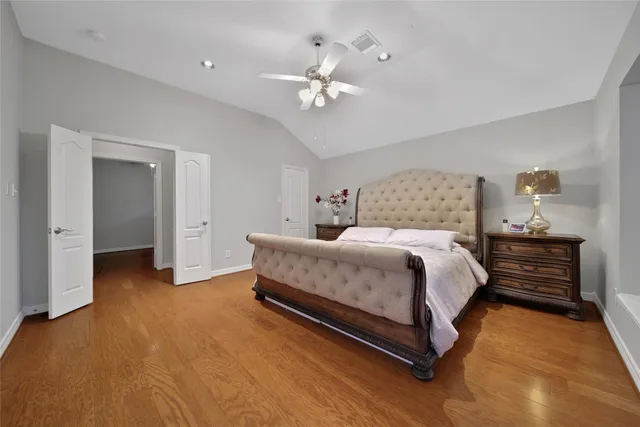 a spacious bedroom with a bed and a chandelier