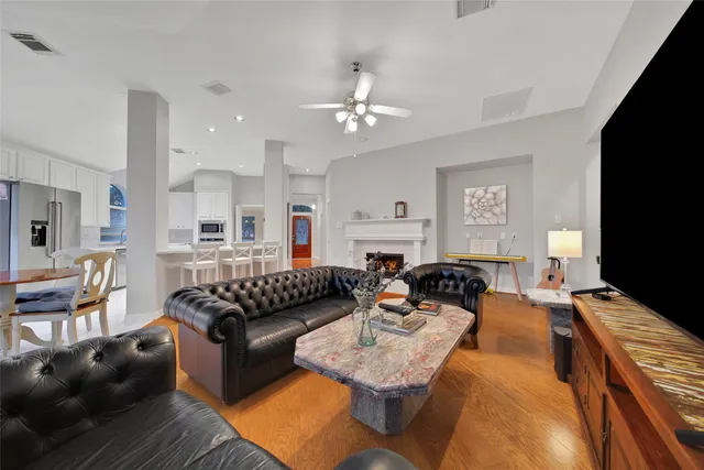 a living room with furniture a fireplace and a flat screen tv