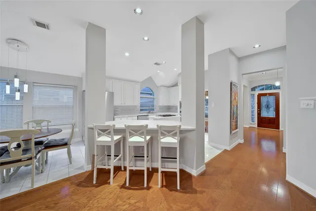 a dining room with furniture and wooden floor