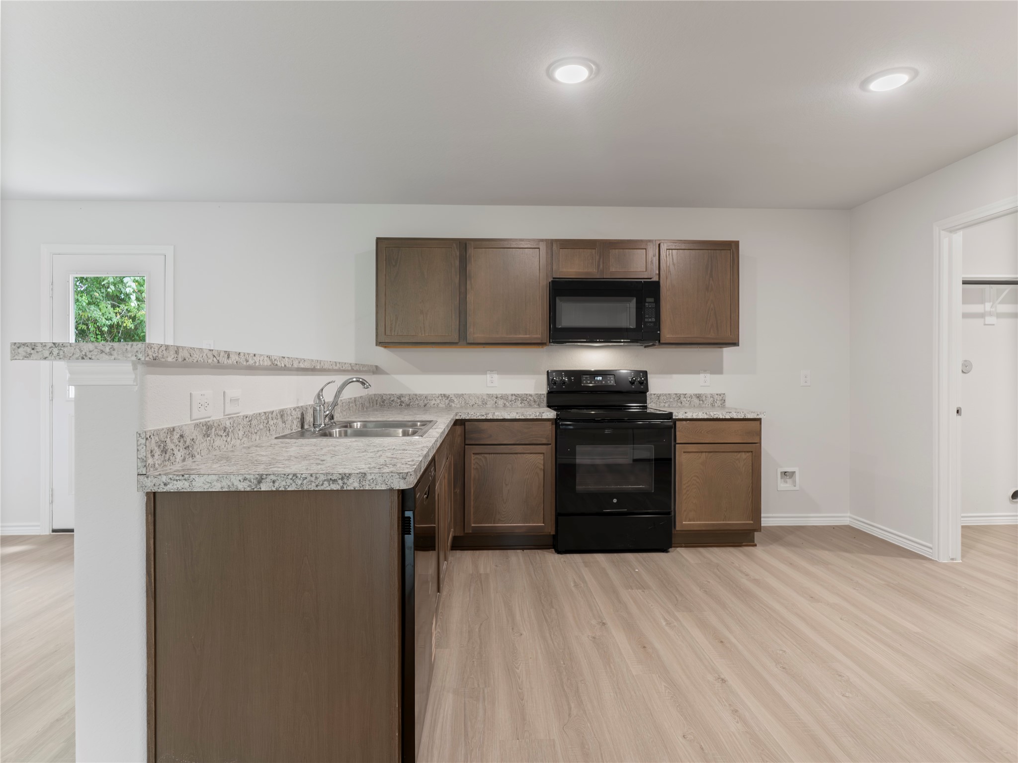 306 North Orange Street Sweeny, TX 77480 - Photo 13 of 30 a kitchen with granite countertop a sink and a stove top oven