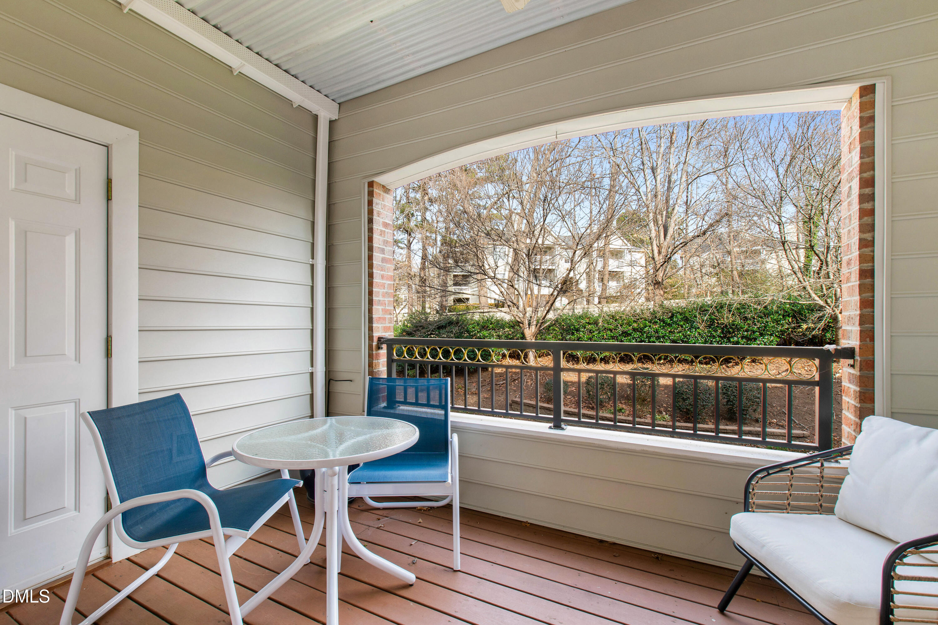 3700 Baron Cooper Pass, Unit 105 Raleigh, NC 27612 - Photo 43 of 49 a balcony with couple of chairs and a table