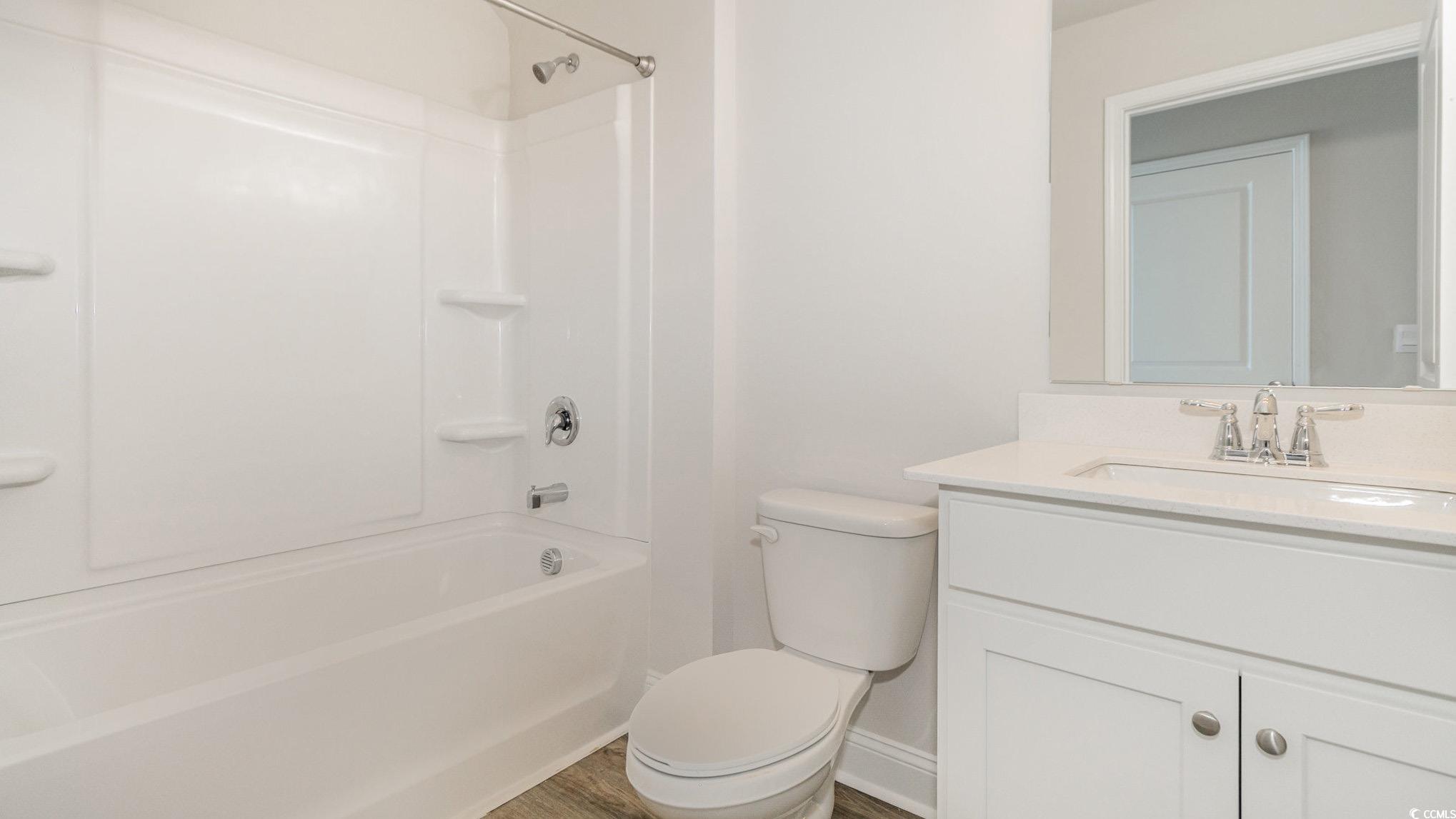 113 Keithland Drive Conway, SC 29527 - Photo 16 of 24 Bathroom with vanity, washtub / shower combination, and wood finished floors