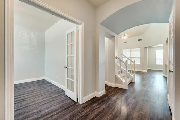 a view of a hallway view with wooden floor and staircase