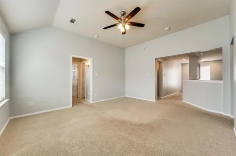 an empty room with closet and a ceiling fan