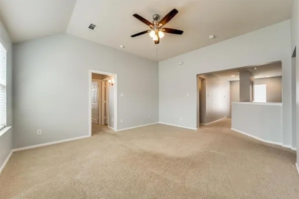 an empty room with closet and a ceiling fan