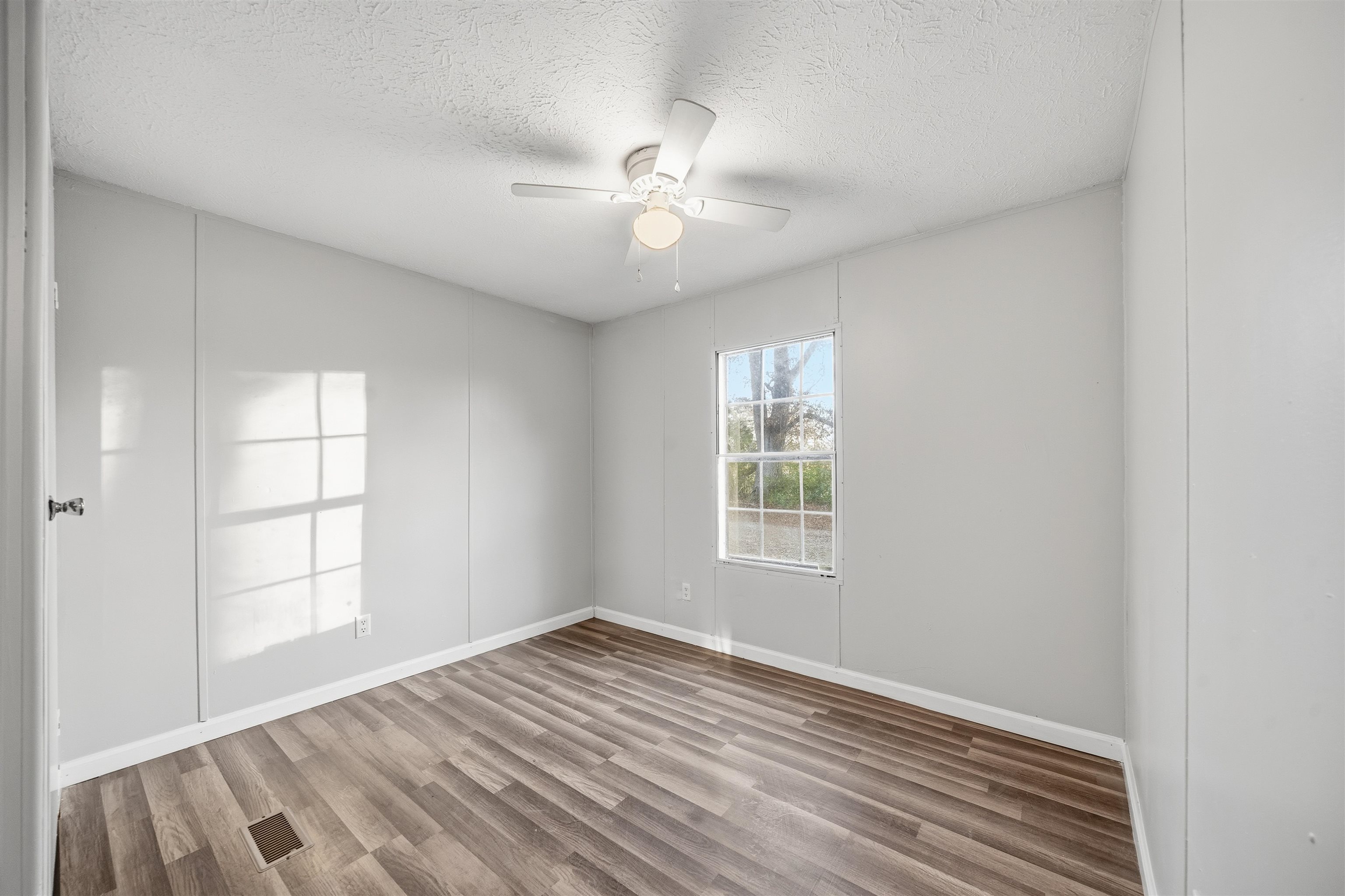 79 Stevens Road Mason, TN 38049 - Photo 14 of 21 wooden floor in an empty room with a window