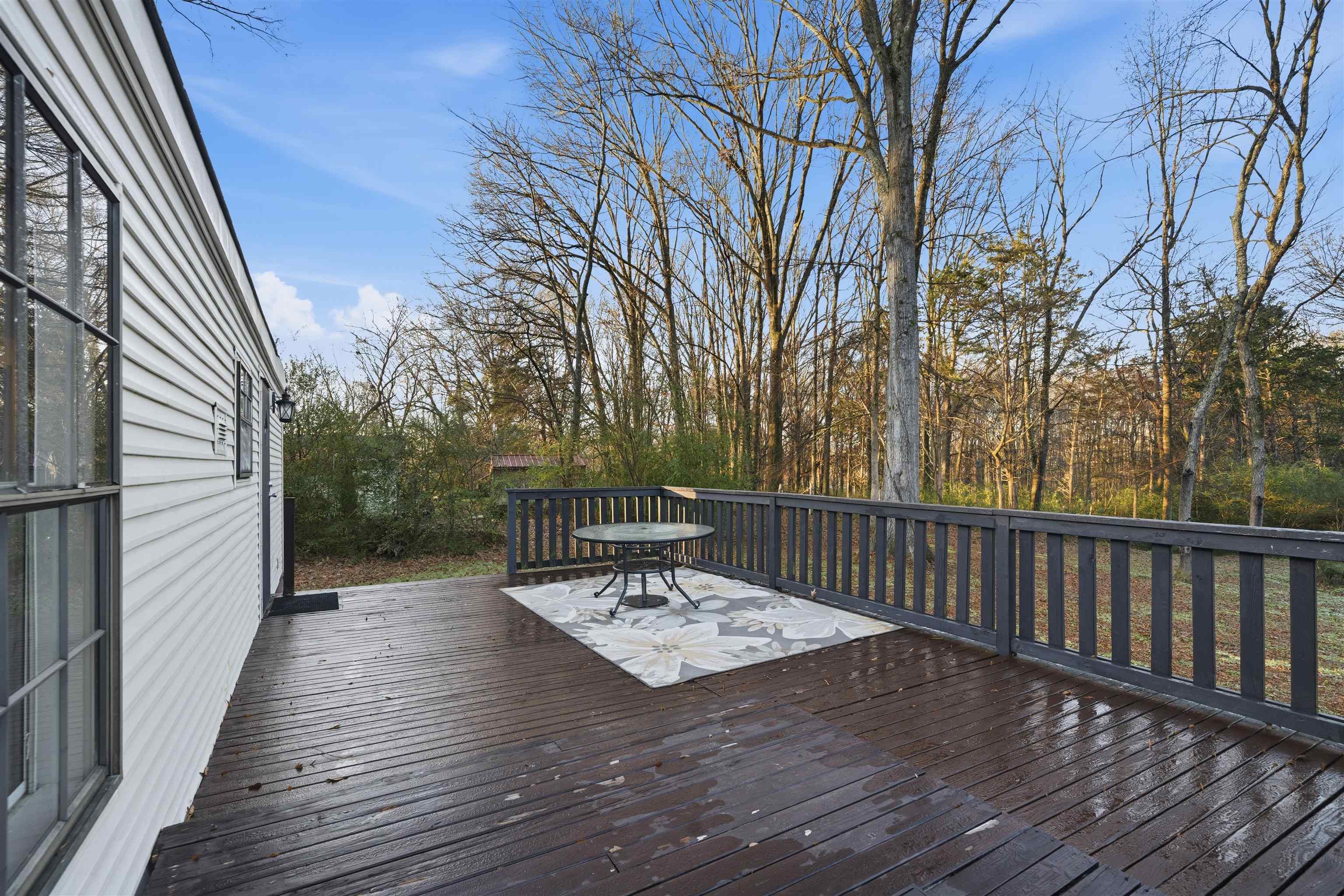 79 Stevens Road Mason, TN 38049 - Photo 19 of 21 a view of a deck with a table and chairs and wooden floor