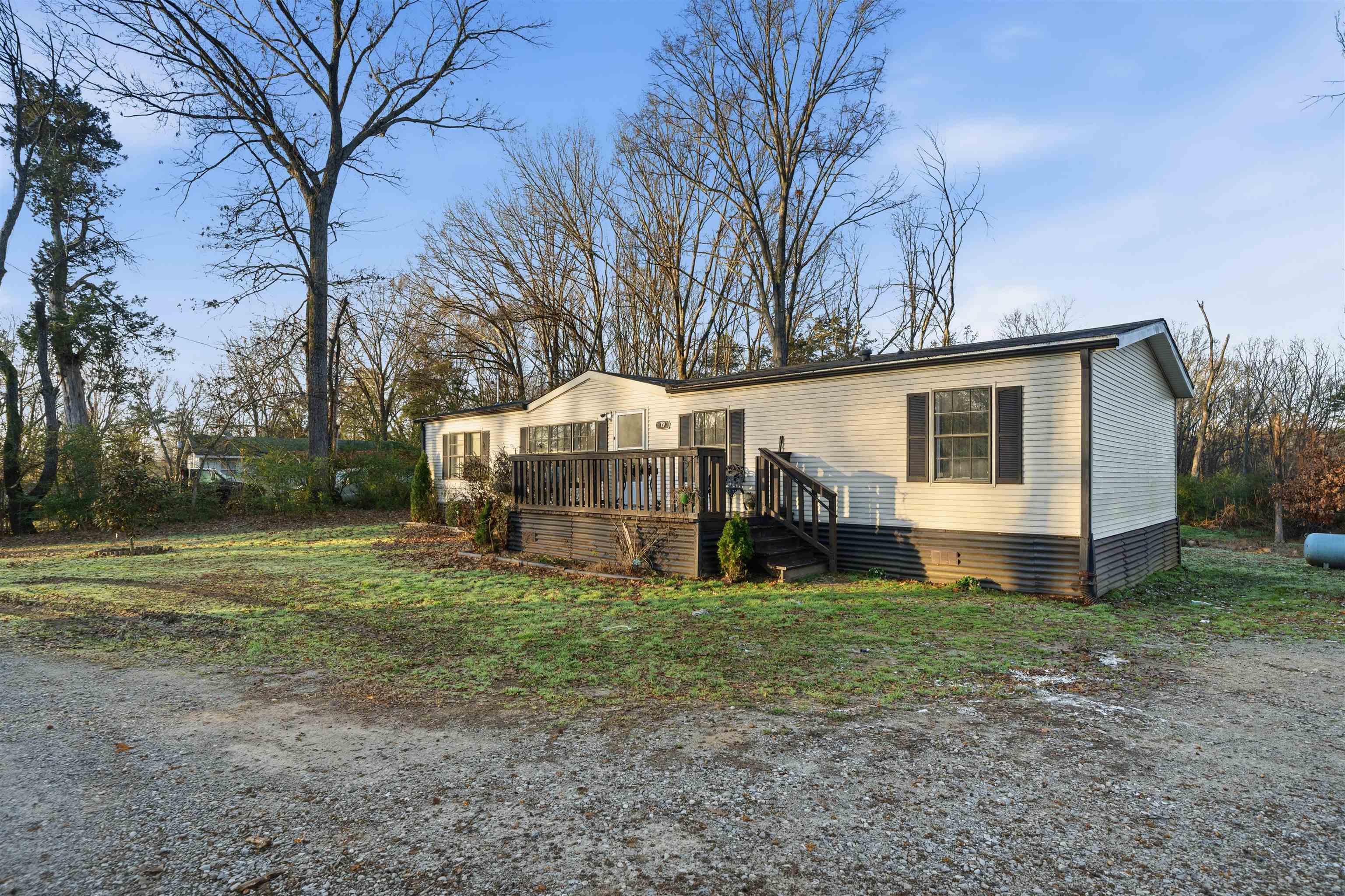 79 Stevens Road Mason, TN 38049 - Photo 2 of 21 a view of a house with backyard and trees
