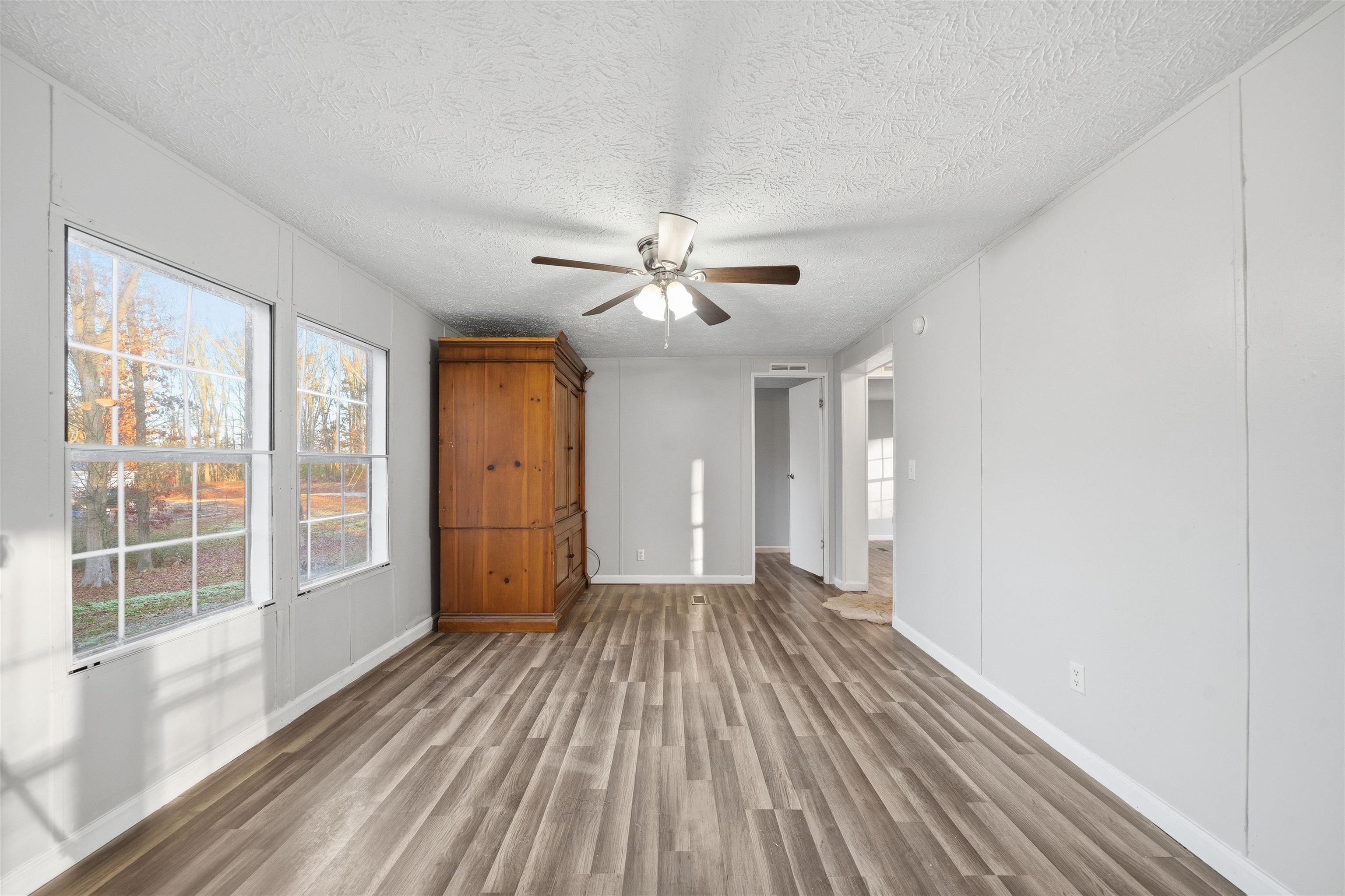 79 Stevens Road Mason, TN 38049 - Photo 8 of 21 Unfurnished living room featuring wood finished floors, a textured ceiling, and ceiling fan