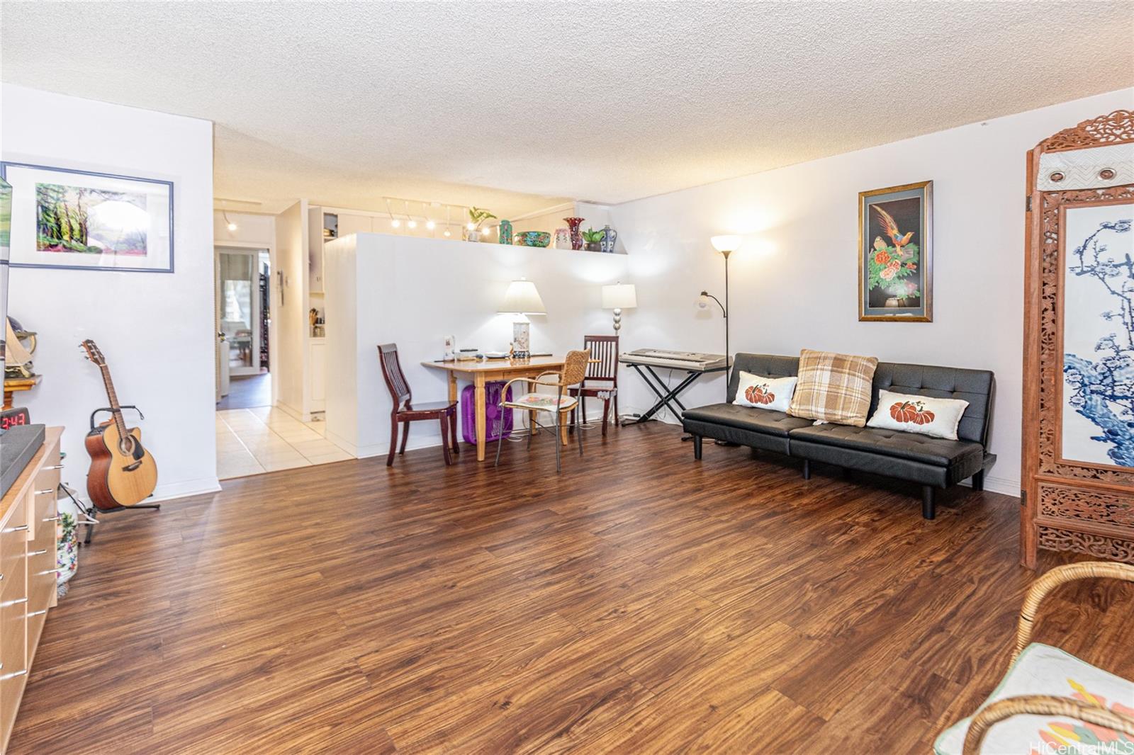a living room with furniture and wooden floor
