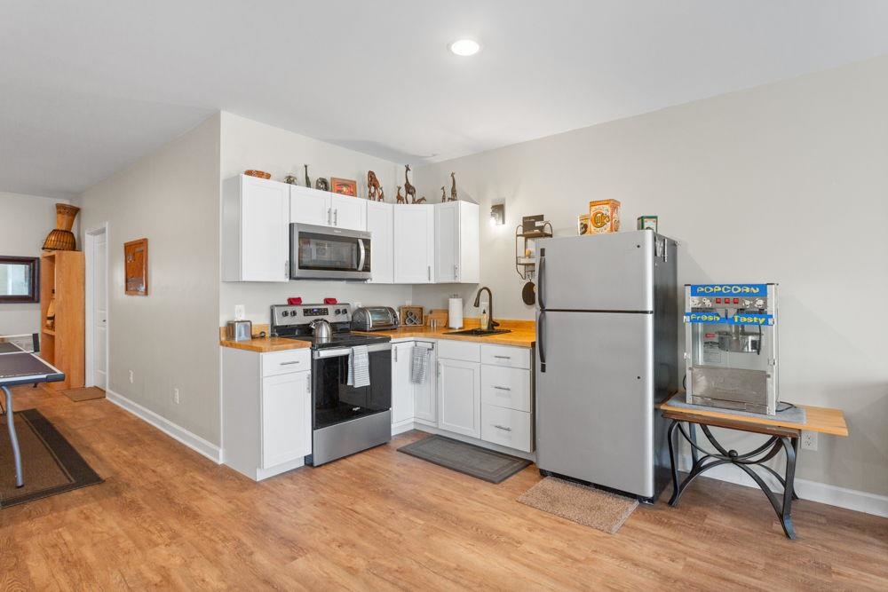 3060 Rutlege Road Harrisonburg, VA 22801 - Photo 22 of 37 a kitchen with refrigerator cabinets and wooden floor