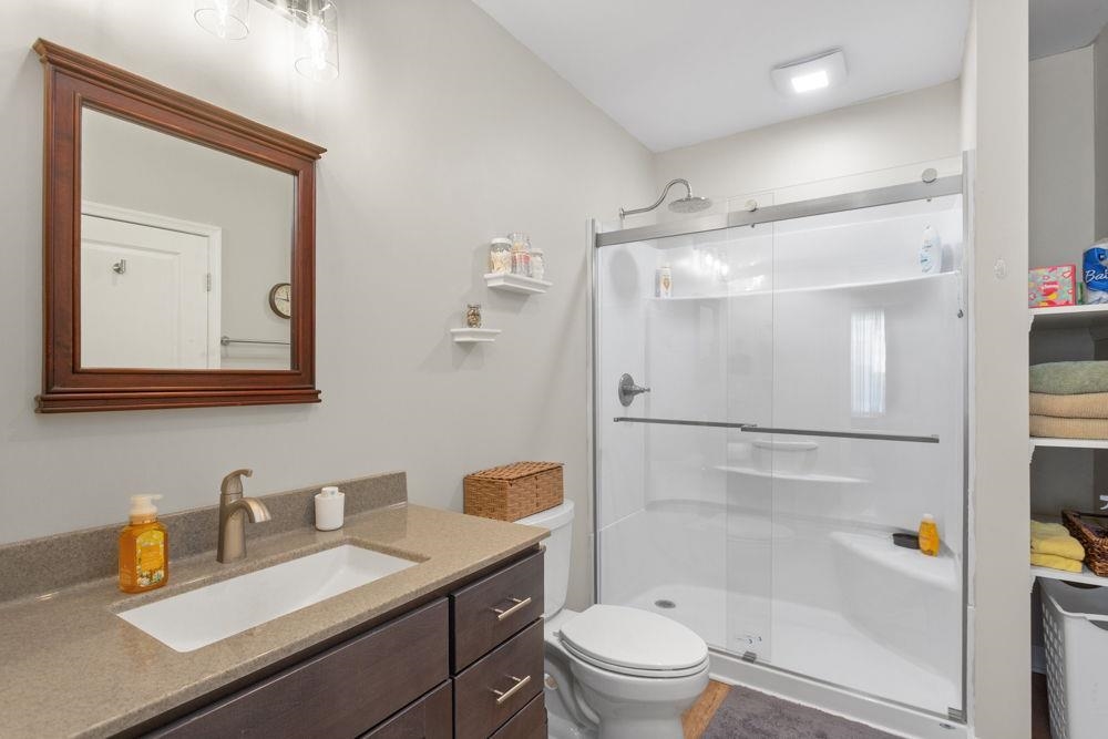 3060 Rutlege Road Harrisonburg, VA 22801 - Photo 26 of 37 a bathroom with a granite countertop sink toilet a mirror a vanity and shower