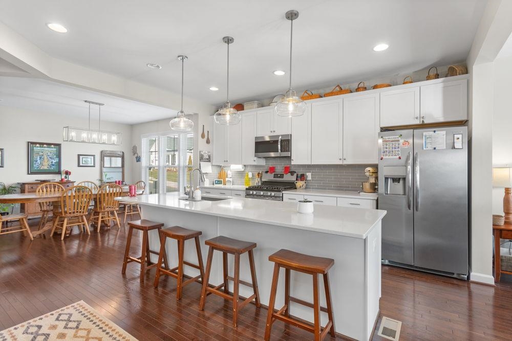 3060 Rutlege Road Harrisonburg, VA 22801 - Photo 6 of 37 a kitchen with stainless steel appliances granite countertop a stove a refrigerator a kitchen island a sink and a refrigerator