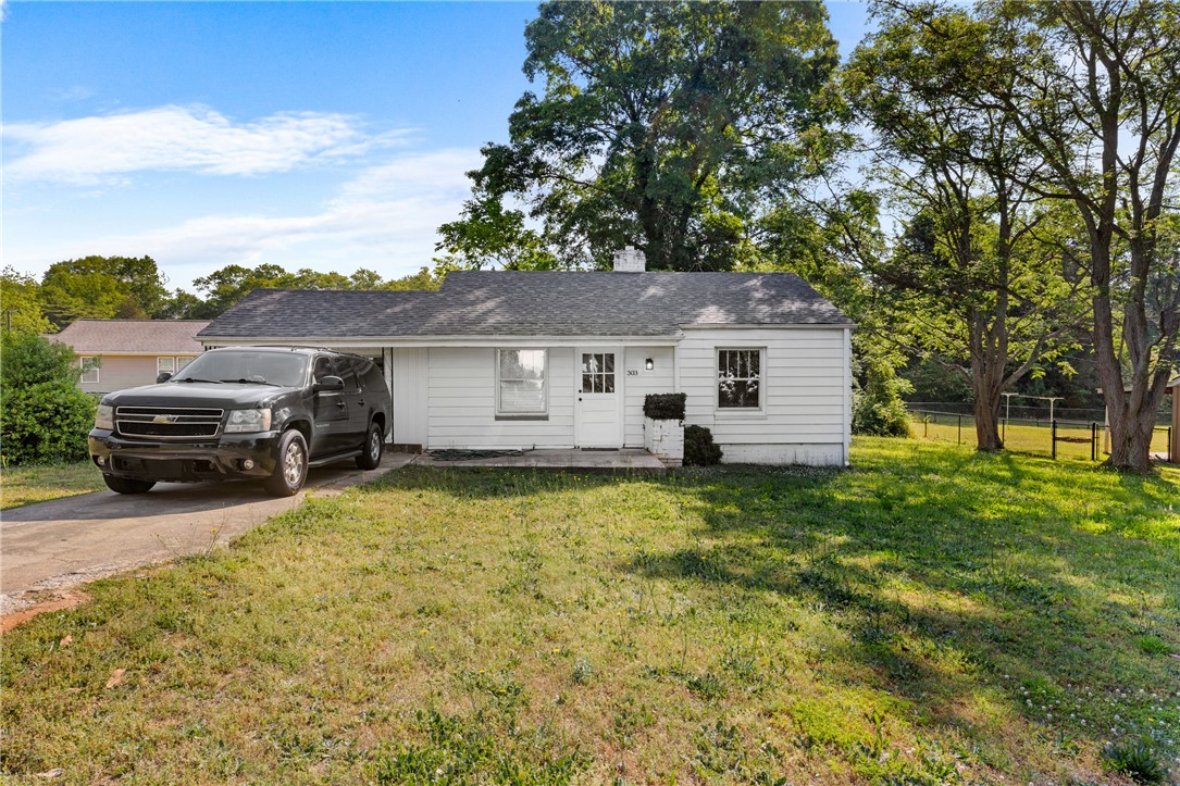 This charming residence features a well-maintained exterior and a comfortable front yard.