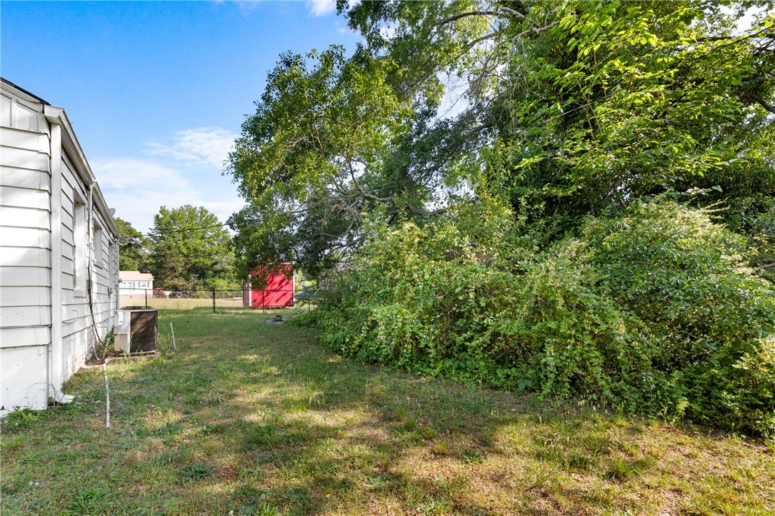 303 South Elm Street Pendleton, SC 29670 - Photo 16 of 16 This spacious yard offers ample green space and a charming red storage shed.